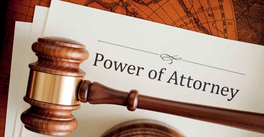 A document that reads "Power of Attorney" with a gavel resting on it