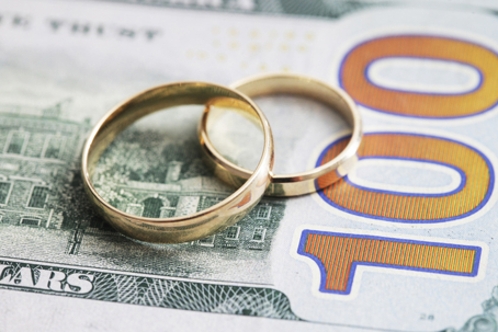 wedding rings on top of money