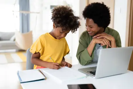 mother helping daughter with her homework